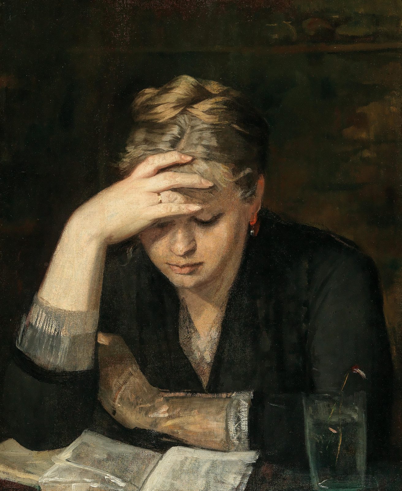 A fair-haired young woman in black reads at a table, her right hand pressed to her forehead and her eyes lowered to an open journal, a glass of water beside her