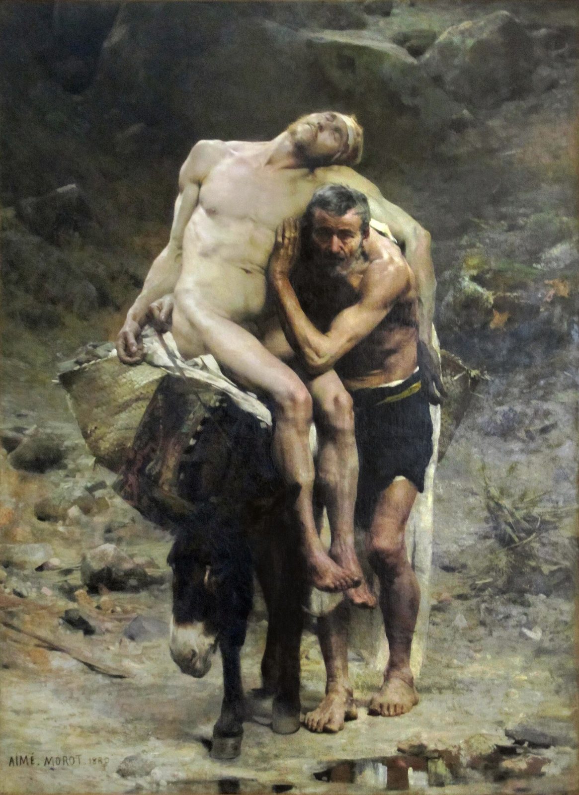 A bearded Samaritan in a turban and oriental robes kneels in a rocky landscape and lifts the limp, half-naked body of a wounded traveller, in a dark, Spanish-seventeenth-century manner