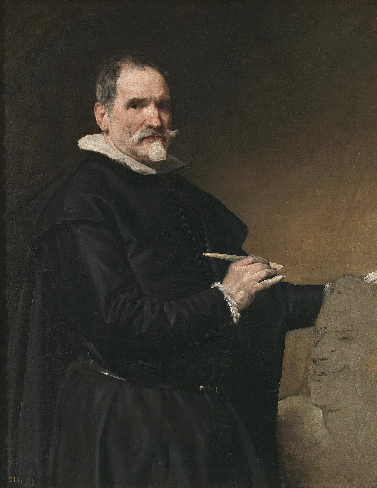 A bearded man in a black coat with a white collar looks out of the canvas, a tool in his right hand over a clay head of a king on his work table