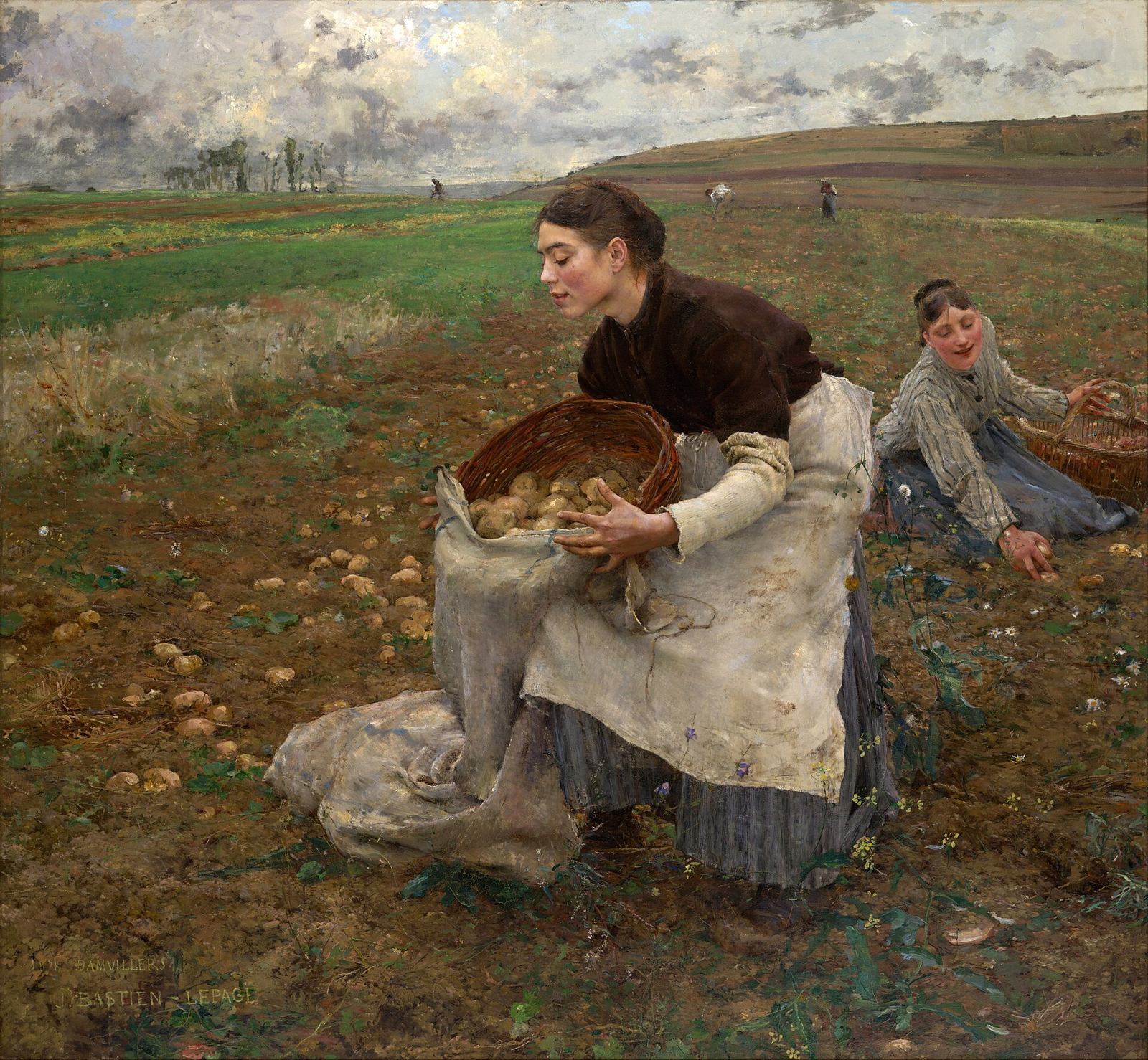 Two peasant women in a freshly dug potato field in autumn, one kneeling and one sitting on the ground, their baskets beside them, the hedge and a village in the haze behind